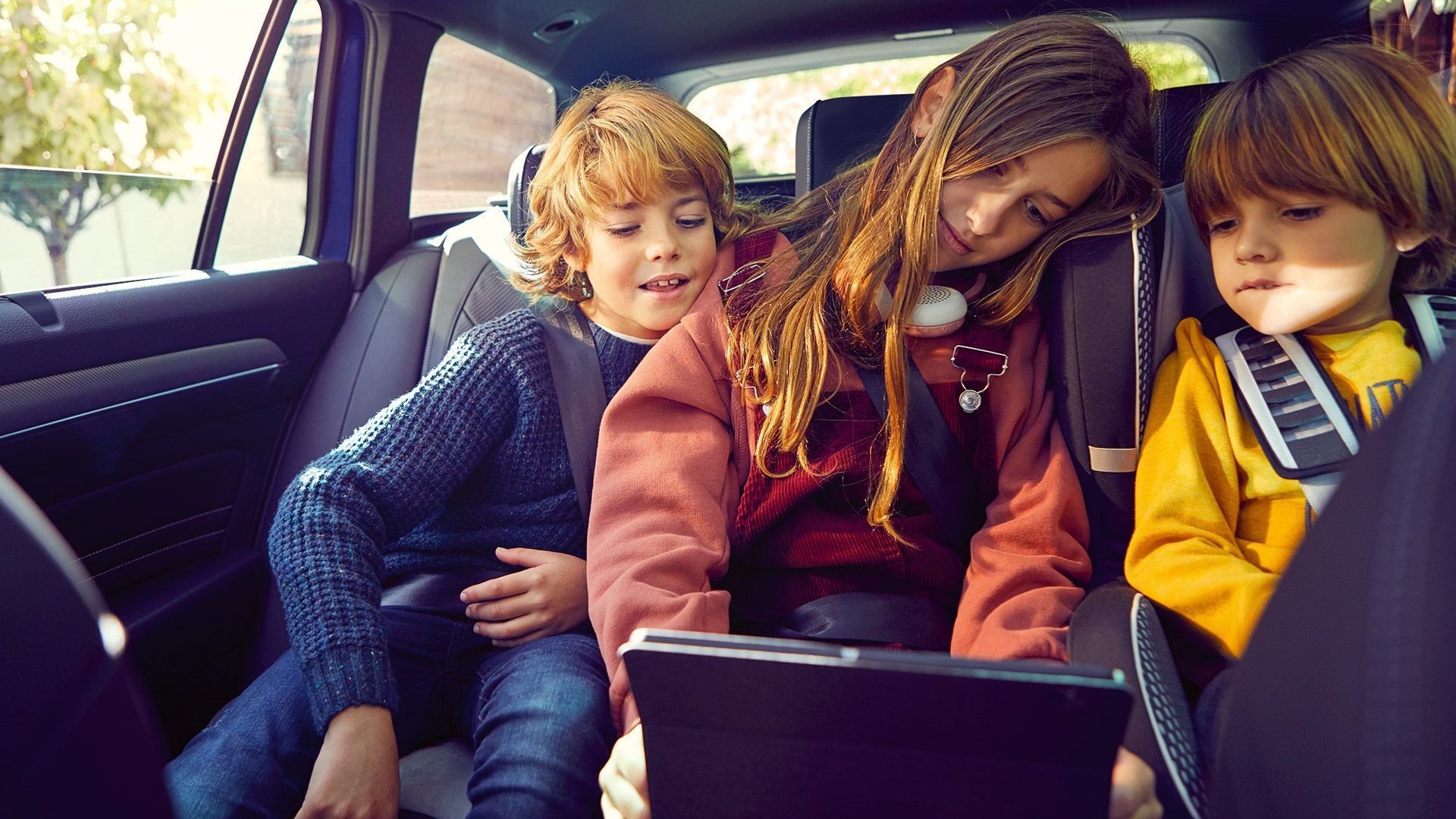 passat interior with kids looking at tablet