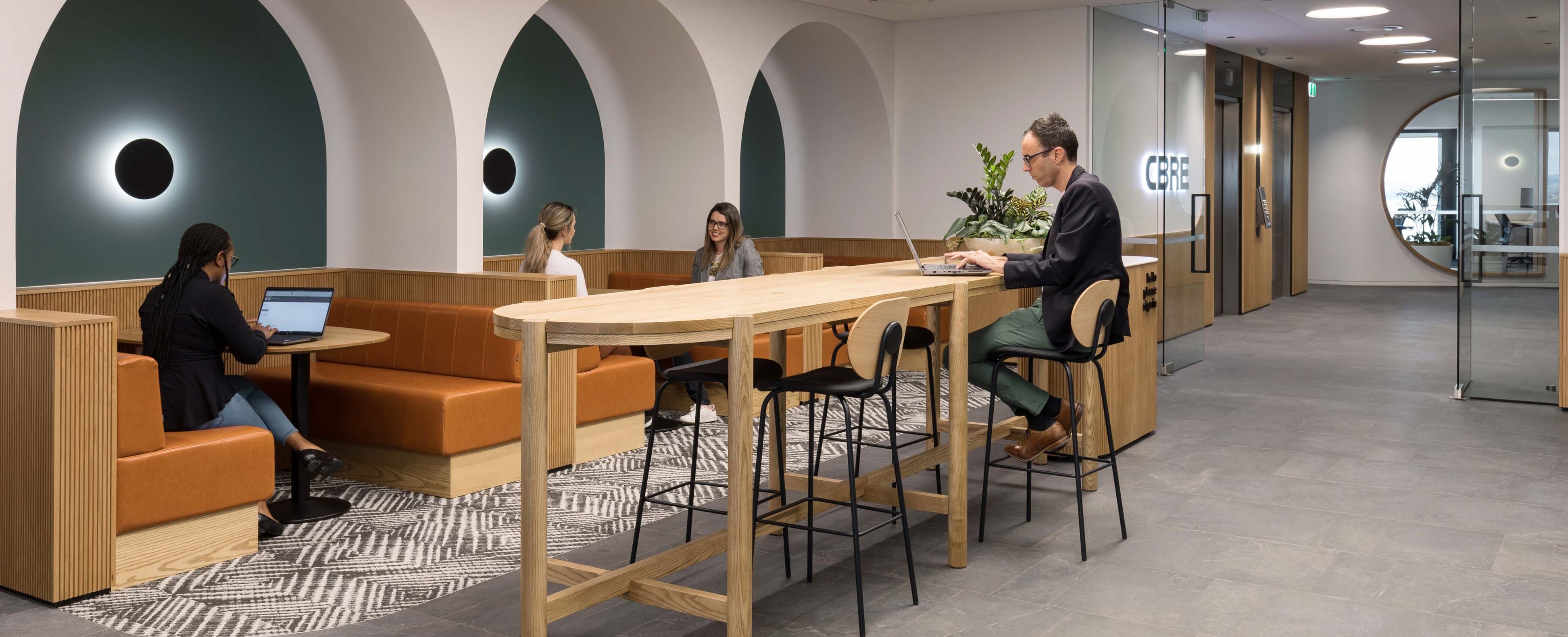 Solace banquettes and bespoke solid timber leaners to create comfortable breakout spaces at CBRE Auckland 
